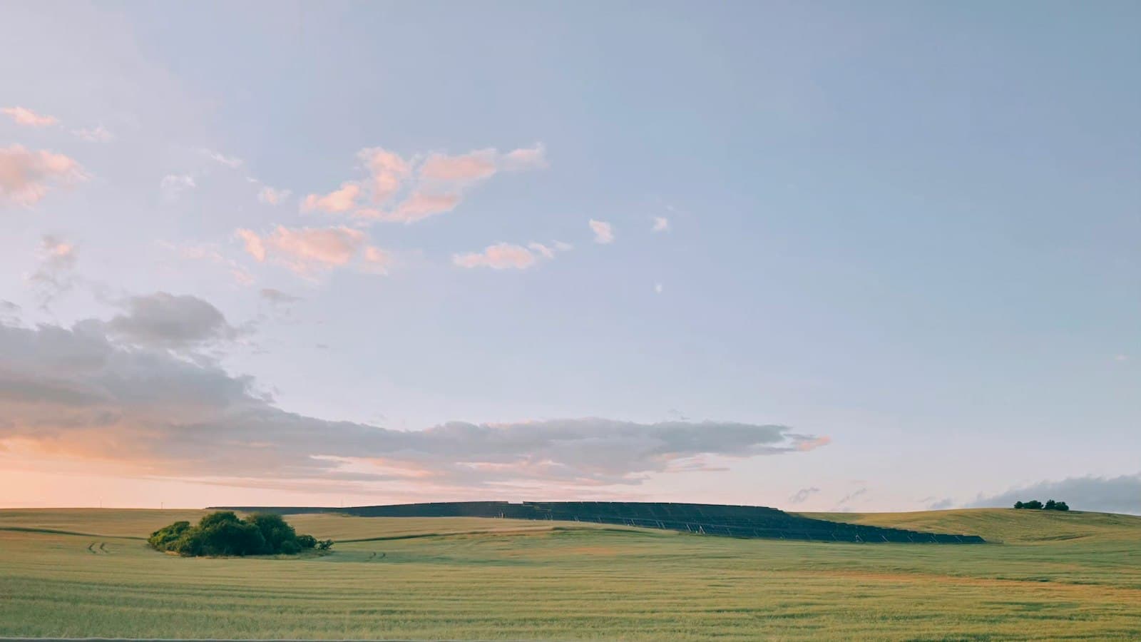 Solar farm on a green hillside